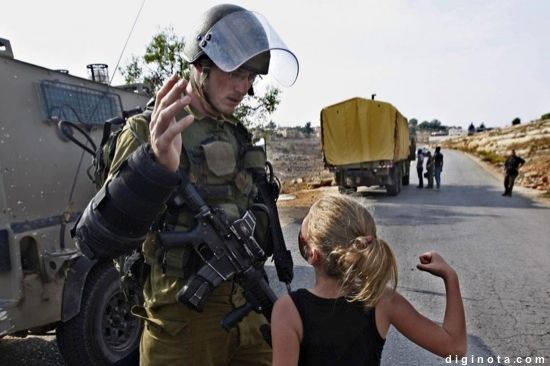 Una niña palestina frente a un soldado israelí